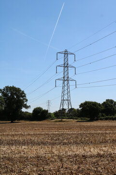 Full frame image of electricity pylon and wires against blue sky
