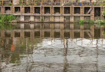 Industrial reflection of Lyons salt waorks in the River Weaver, Anderton Boat Lift, Anderton, Cheshire, UK