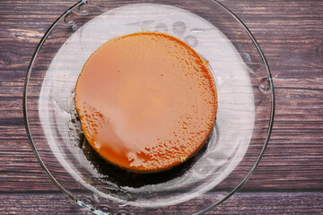  Caramel custard pudding on a plate on table 