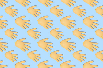 Fototapeta premium Seamless pattern with inflated yellow medical gloves on a blue background. Prevention and protection of coronavirus, covid-19. Healthcare concept. Abstract background.