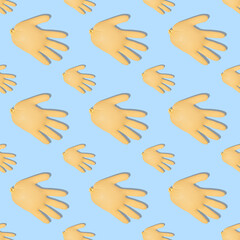 Seamless pattern with inflated yellow medical gloves on a blue background. Prevention and protection of coronavirus, covid-19. Healthcare concept. Abstract background.