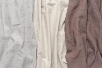 Samples of linen fabric in grey, beige and brown colors. Concept of natural eco textiles.