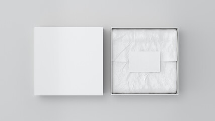 Square gift box mock up. White gift box with blank label or business card on wrapping paper. White background. View directly above.