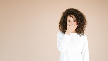 Portrait of anxious scared young african american girl isolated over beige background. Negative emotions, human reaction, expression      