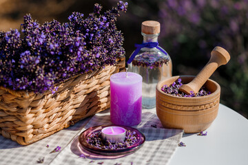 Fototapeta na wymiar Wooden bowl with dried lavender on field background. Flower herbal tea drink. Aromatherapy, medicine ingredient. Calming beverage