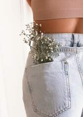 flowers in the pocket of jeans