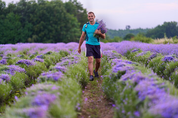 Happy farmer in his lavender field at harvest