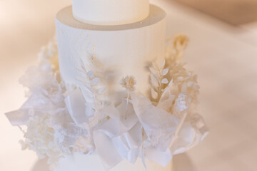 Beautiful wedding cake decorated with white flowers