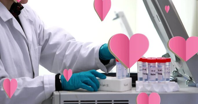 Animation of falling hearts over scientist in laboratory