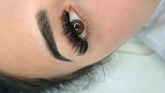 Lash extensions in beauty salon macro eye top view . High quality photo