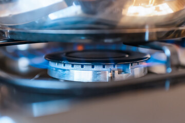 Combustion of household gas on a gas stove, gas energy saving concept.Closeup. - obrazy, fototapety, plakaty