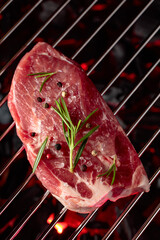 Raw steak on a grill.