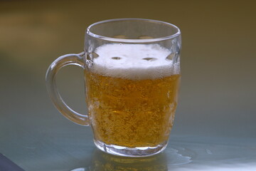 On the table in a mug fresh , light beer .