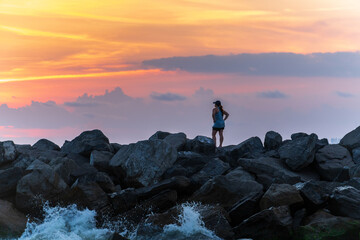 Woman watching sunset from jetties