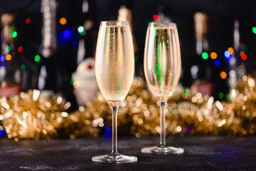 Champagne glasses on a dark background.