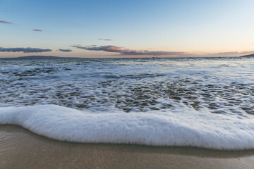 Maui Hawaii beach coastline of sand, sun, and blue water with crashing