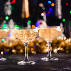 Champagne glasses on a dark background.