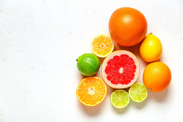 Fresh lemon, orange, grapefruit, lime on light background, top view.
