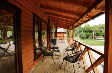 Wooden terrace in a modern country house, with an onboard platform and garden furniture