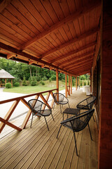 Wooden terrace in a modern country house, with an onboard platform and garden furniture