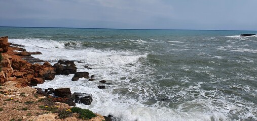 Beautiful sea in Spain.
Stone coast of the sea. Marine background. Sea waves on the rocks.