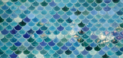 Beautiful mosaic tiles in a marine style. Tile with a sea pattern. Blue tiles with a geometric pattern of scales. 