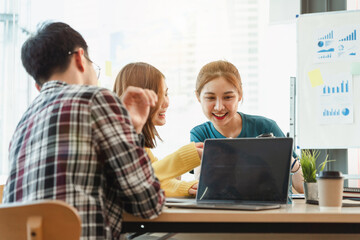 Young Asian team working together in business modern office, Start up business.