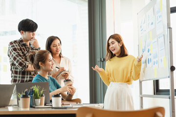 Smart professional Start up new business Asian people present enterprise start-up development project point white board charts paper people sit table desk listen human resources training in office.