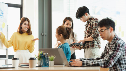 Smart professional Start up new business Asian people present enterprise start-up development project point white board charts paper people sit table desk listen human resources training in office.