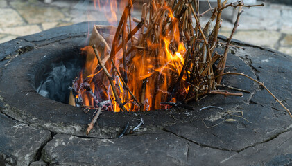 Traditional Caucasian wood-burning stone-brick tandoor oven for cooking shish kebab, fish, pita...