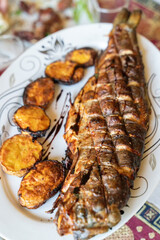 Fish and potatoes cooked in traditional Turkish and Caucasian tandoor.