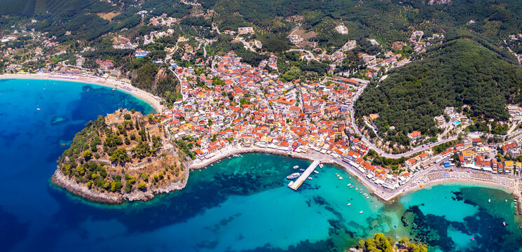 Aerial drone view of Parga colorful town with venetian castle and  beach Valtos . Epirus, Greece summer destinations and popular resorts