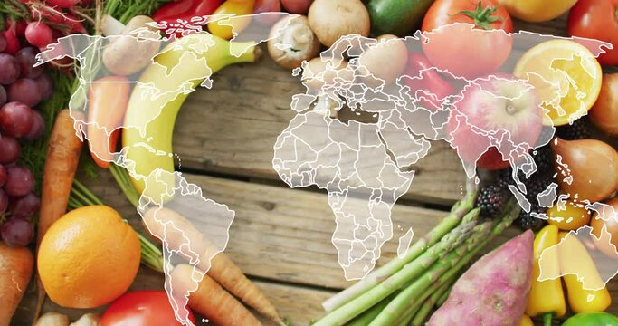 Animation of world map over fruits and vegetable lying on table