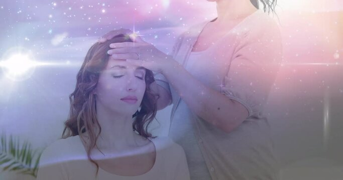 Animation of stars and galaxy moving over caucasian woman healing female customer