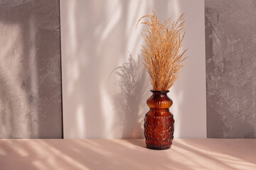 Stylish modern Natural dried pampas grass in brown vase on a natural background. Composition in the style of minimalism.