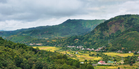 Typical Madagascar landscape at Mandraka region. Hills covered with green foliage, small villages...