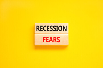 Recession fears symbol. Concept words Recession fears on wooden blocks on a beautiful yellow table yellow background. Business and recession fears concept. Copy space.