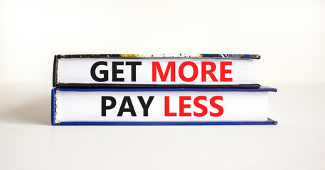 Get more pay less symbol. Concept words Get more pay less on books on a beautiful white table white background. Business Get more pay less concept. Copy space.