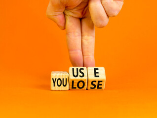 You use or lose it symbol. Concept words You use and You lose on wooden cubes. Businessman hand....