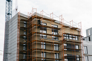 scaffolding at the construction site of stylish apartment buildings, yard area