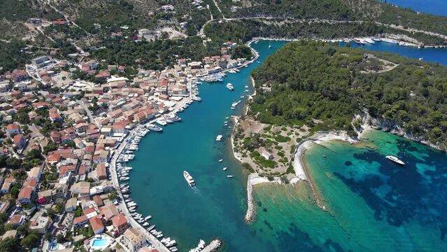 Aerial drone video of iconic port of Gaios a natural fjord bay ideal for safe anchorage in island of Paxos, Ionian, Greece