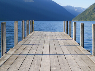 Jetty on Lake Roto-iti projecting into lake with mountain background