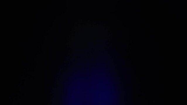 Hand quickly revealing a small bag of cannabis to the camera with red and blue police car lights flashing (Loopable) 