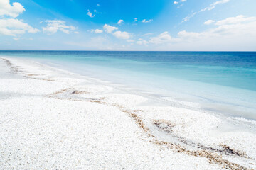 White pebbles and blue sea in Stintino shore