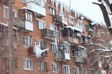 Russia. Terrible huge icicles formed on the balcony of a multi-storey building due to a poor roof storm system