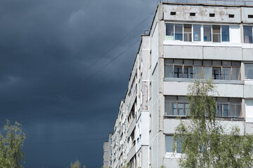 Dark blue stormy sky and high-rise building