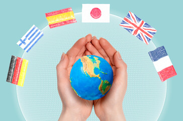 International interpreter. Woman's hands hold a small globe of the planet Earth, close-up. Light blue background with a digital sphere and flags. Concept of linguistics and learning foreign languages