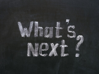 Words What`s Next? written by a chalk on a chalkboard