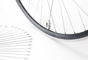 bicycle wheel and spare spokes, on an isolated white background