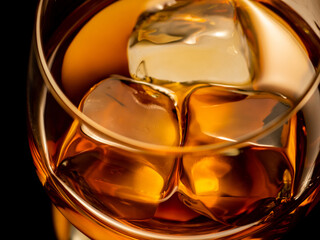 Whisky on the rocks, glass filled with ice cubes
